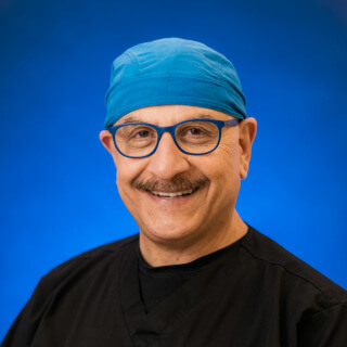 Dr. Abdollah Malek in scrubs smiling